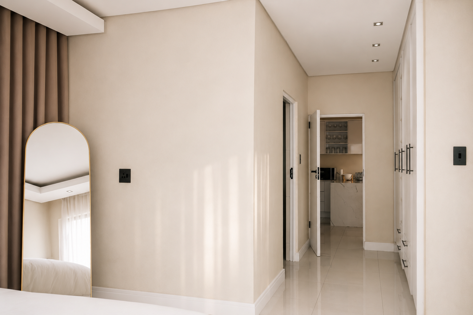 Bedroom passage with arched mirror and fitted wardrobes