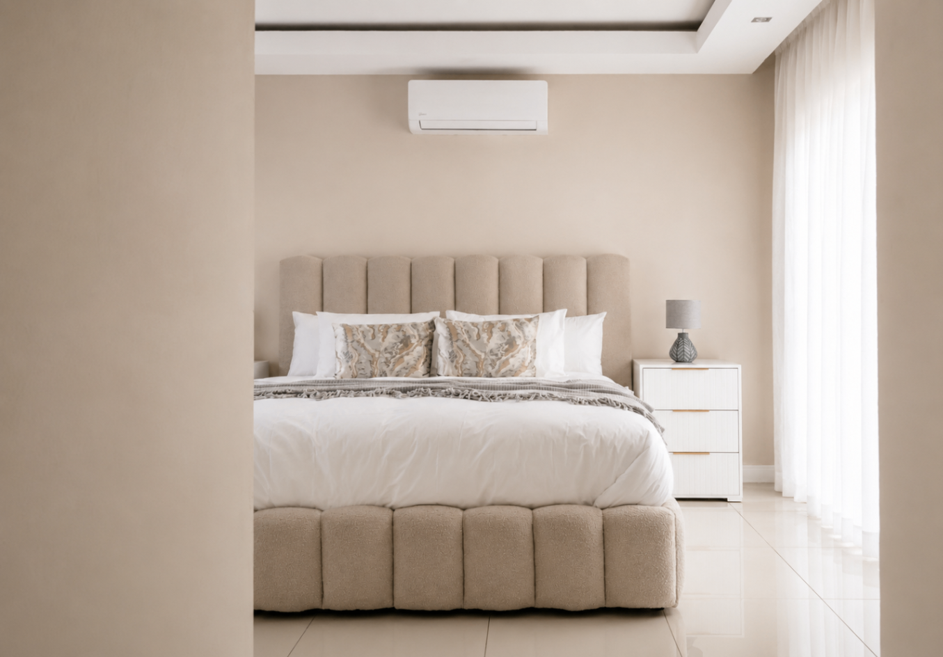 Bedroom with tufted bouclé bed and bedside lamp