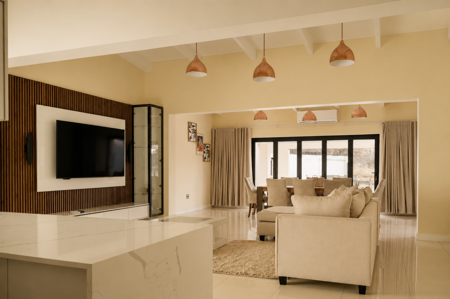 Open-plan living and dining room with warm pendant lighting