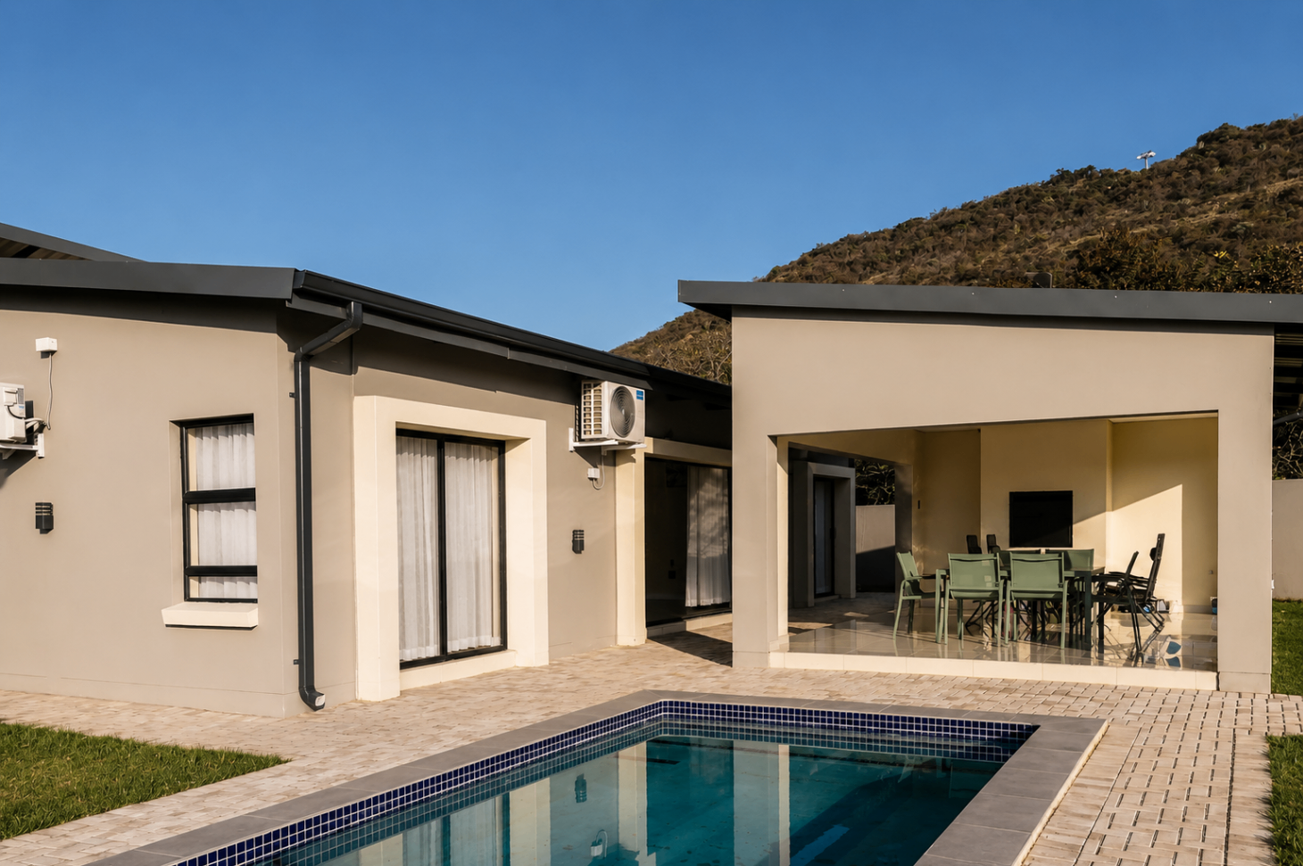 Private pool, sun loungers and patio at Chilla Signature Villa at sunset